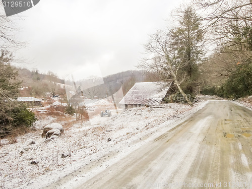 Image of winter shack and mountain  farm road