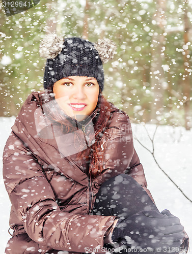 Image of Portrait of the charming young woman in winter outdoors 