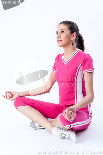 Image of Attractive woman doing yoga exercise