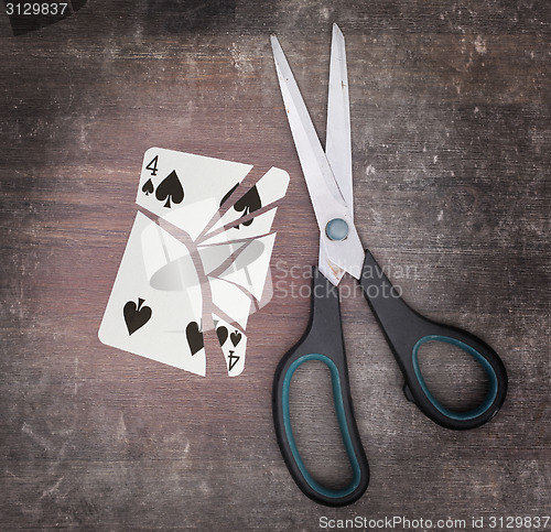 Image of Concept of addiction, card with scissors