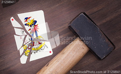 Image of Hammer with a broken card, joker