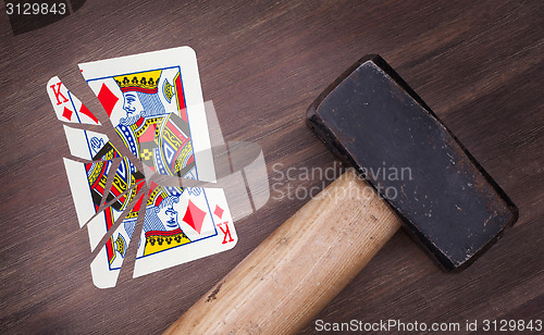 Image of Hammer with a broken card, king of diamonds