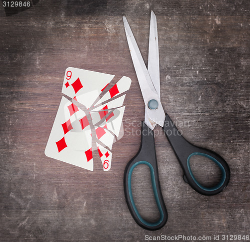 Image of Concept of addiction, card with scissors