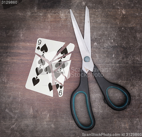 Image of Concept of addiction, card with scissors