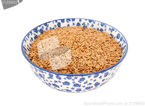 Image of Golden linseed or flax seeds in a blue and white china bowl