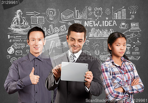 Image of Asian team and Businessman With Touch Pad