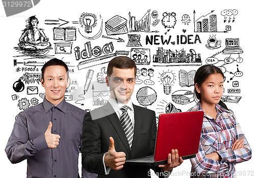 Image of Asian team and male in suit with laptop in his hands