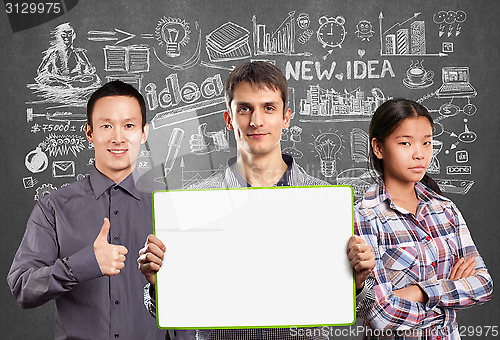 Image of Asian team and male with write board in his hands