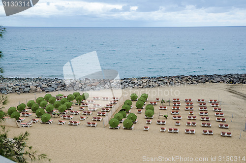 Image of Empty sun beds at beach