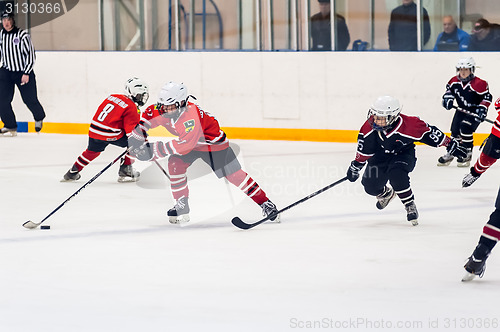 Image of Game moment of children ice-hockey teams