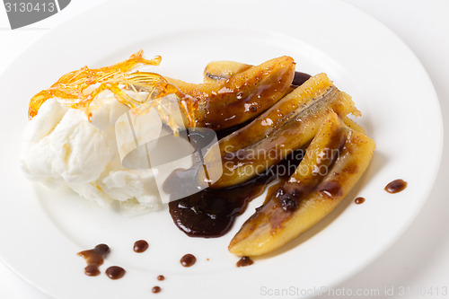 Image of Fried bananas, sauce and ice cream