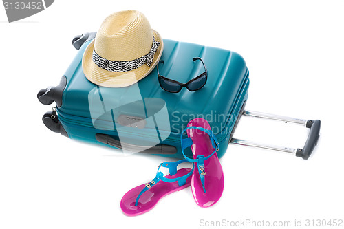 Image of Blue plastic bag, straw hat, sunglasses and beach shales