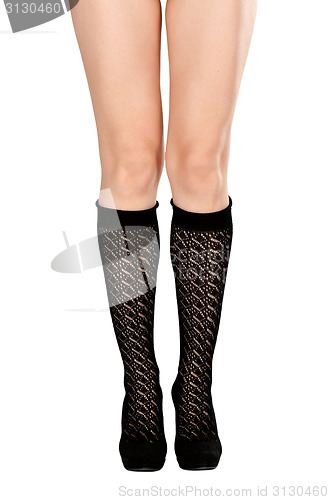 Image of female legs in fishnet socks and shoes