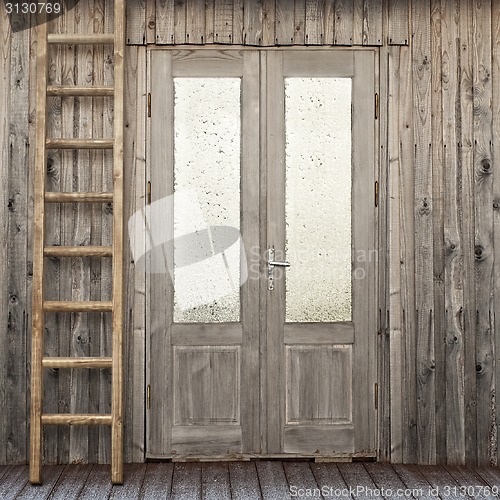 Image of door with frosty window of plank house