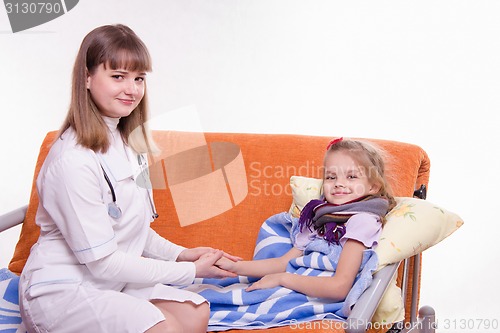 Image of Pediatrician holding a sick child's hand