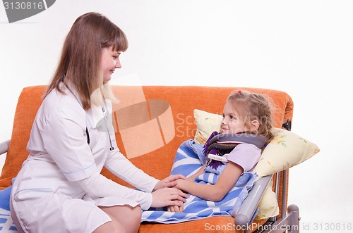 Image of Doctor comforting a sick child