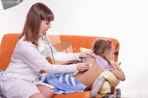 Image of Pediatrician listening stethoscope baby back