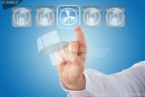 Image of Finger Selecting Wind Energy Among Nuclear Icons