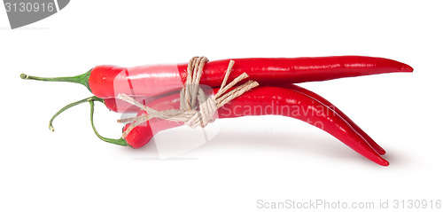 Image of Three red chili peppers tied with a rope reversed