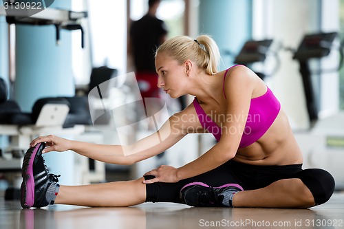 Image of woman stretching and warming up for her training at a gym