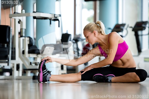 Image of woman stretching and warming up for her training at a gym