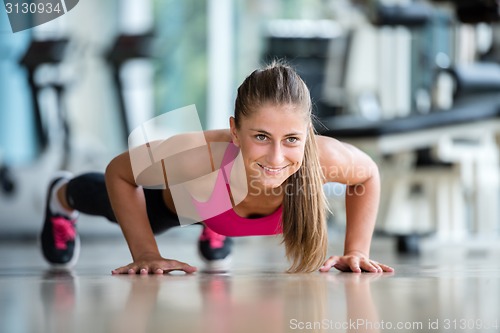 Image of warming up and doing some push ups a the gym