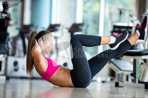 Image of woman stretching and warming up for her training at a gym