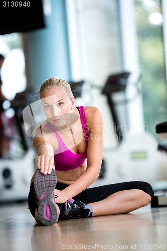 Image of woman stretching and warming up for her training at a gym