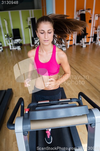 Image of woman exercising on treadmill in gym