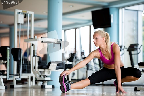 Image of woman stretching and warming up for her training at a gym