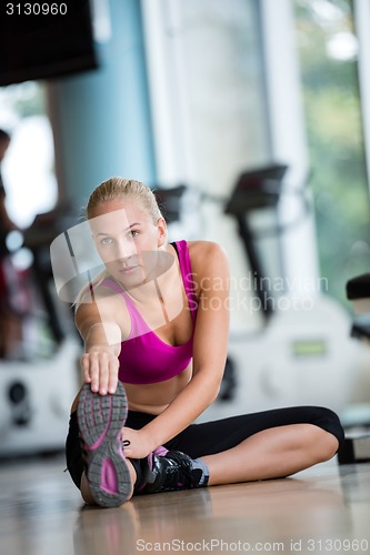 Image of woman stretching and warming up for her training at a gym