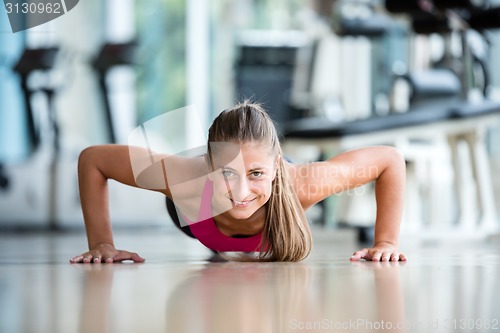 Image of warming up and doing some push ups a the gym