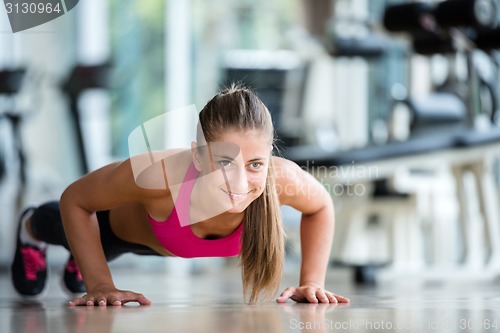 Image of warming up and doing some push ups a the gym