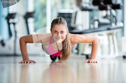 Image of warming up and doing some push ups a the gym