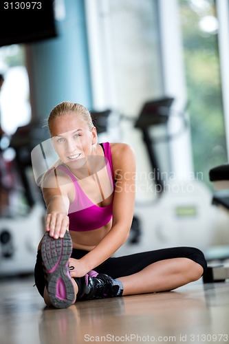 Image of woman stretching and warming up for her training at a gym