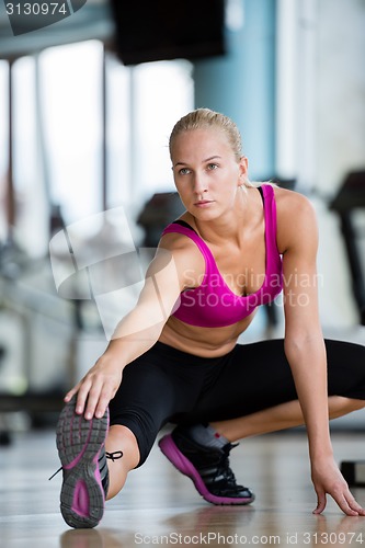 Image of woman stretching and warming up for her training at a gym