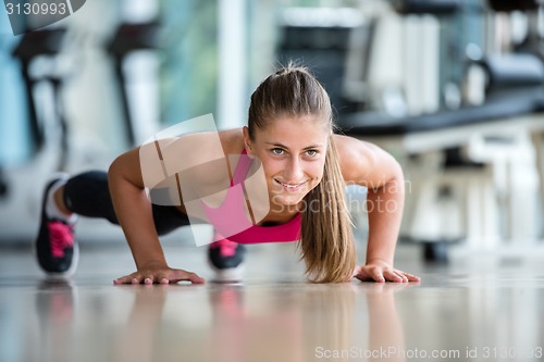 Image of warming up and doing some push ups a the gym