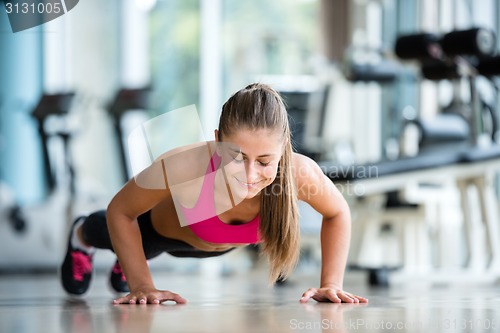 Image of warming up and doing some push ups a the gym