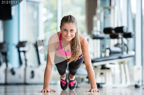 Image of warming up and doing some push ups a the gym