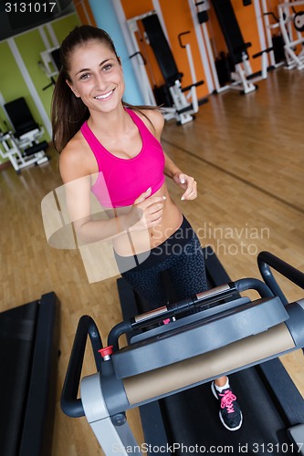 Image of woman exercising on treadmill in gym
