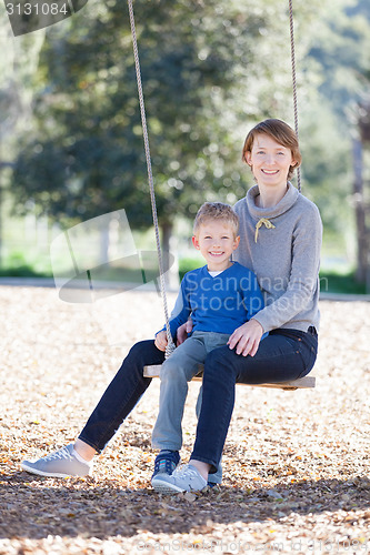 Image of family at swings