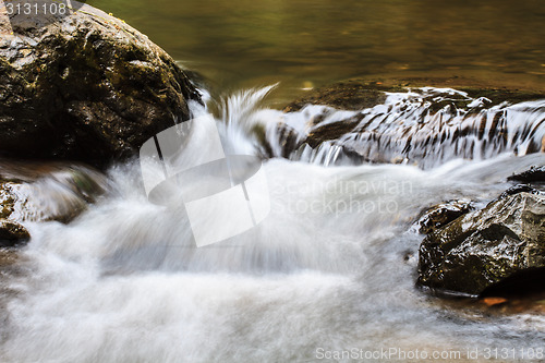 Image of waterfall and rocks covered with moss