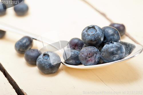 Image of fresh blueberry on silver spoon