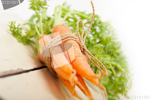 Image of baby carrots bunch tied with rope