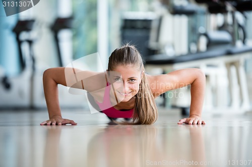 Image of warming up and doing some push ups a the gym