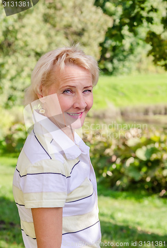 Image of Portrait of a middle-aged woman in a park on a sunny day