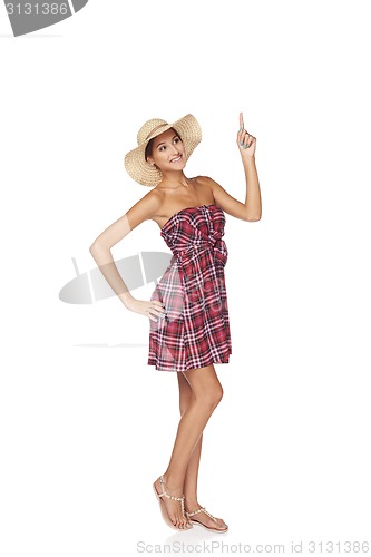 Image of Happy young woman pointing up