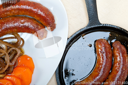 Image of beef sausages cooked on iron skillet 