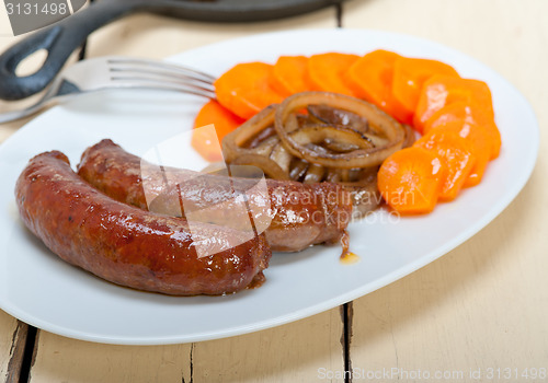 Image of beef sausages cooked on iron skillet 