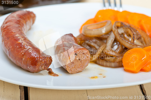 Image of beef sausages cooked on iron skillet 